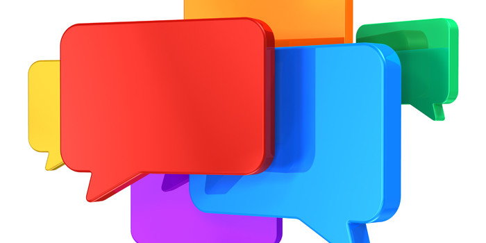 Social networking media, chat, messaging and communication concept: group of glossy colorful speech bubbles isolated on white background